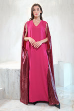 Load image into Gallery viewer, A woman standing in a luxurious setting wearing a deep fuchsia crepe dress with a shiny magenta pink cape.