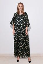 Load image into Gallery viewer, A model wearing a long, polka dot cream organza dress with a V-neck and wide bell-shaped sleeves, standing against a neutral background.
